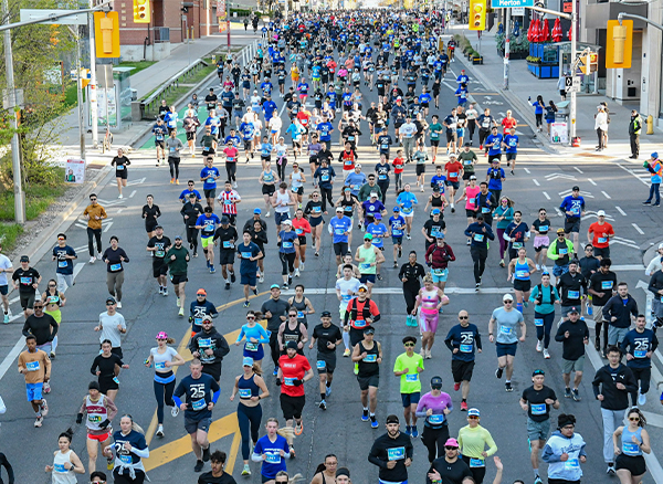 Sporting Life 10K 2024 Runners in front of the CN Tower
